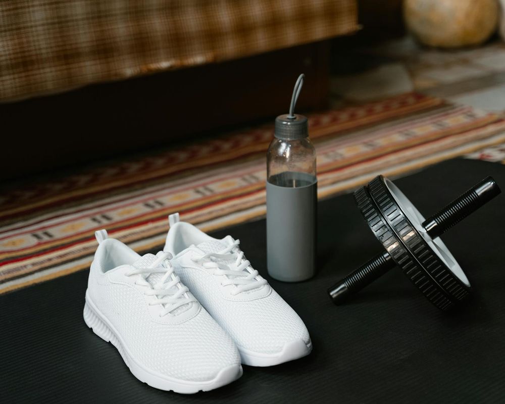 Detail of a sports mat and water bottle in morning light.