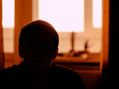 Silhouette of a person moving gracefully against the window.