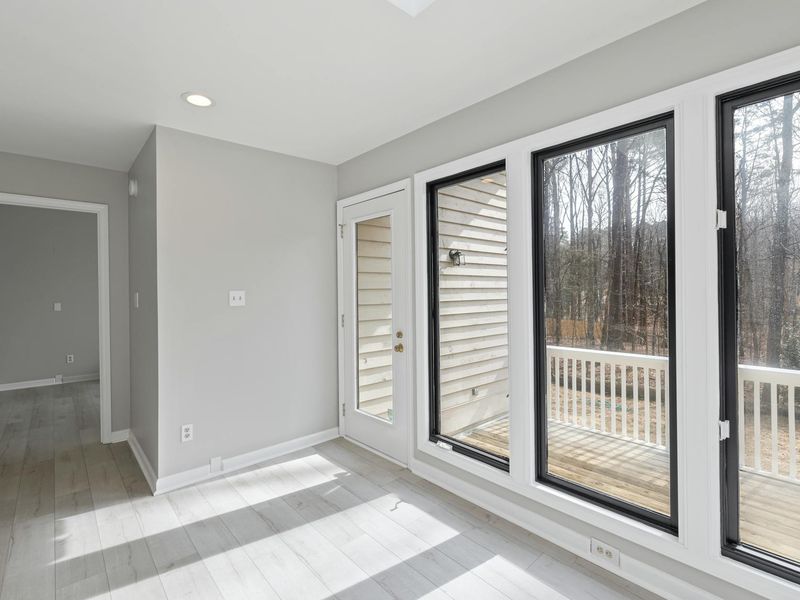 Wide shot of a clean, minimalist sunlit exercise room.